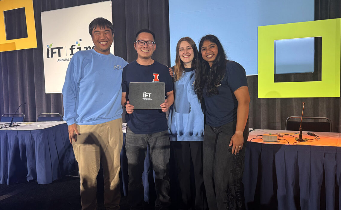 The four team members who competed standing together on stage at the competition.