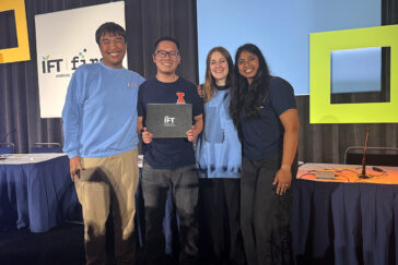 The four team members who competed standing together on stage at the competition.