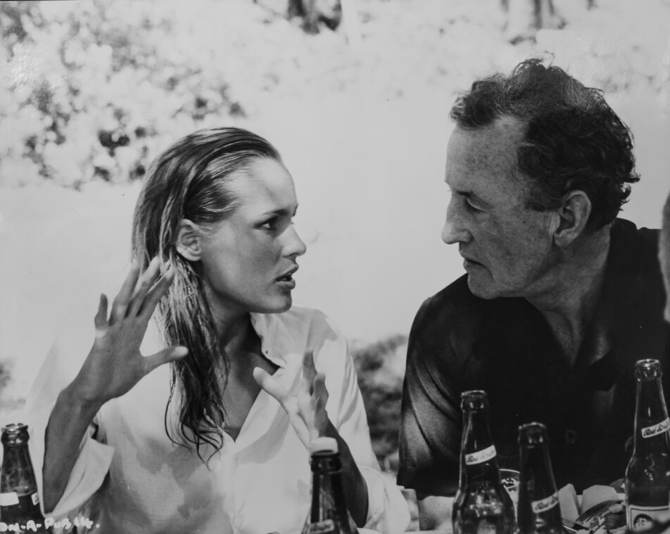 A black and white photo of Ian Fleming with Ursula Andress, the Bond girl from “Dr. No.”