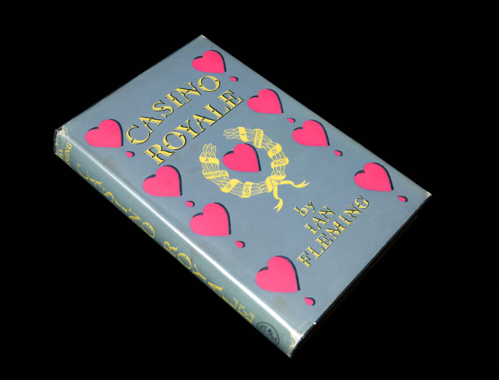 A photo of an edition of “Casino Royale” with pink hearts on the dust jacket cover.