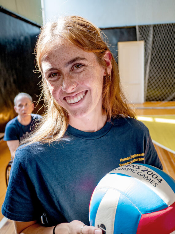 Photo of Thornton holding a rugby ball and smiling.