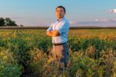A researcher standing in an agricultural field