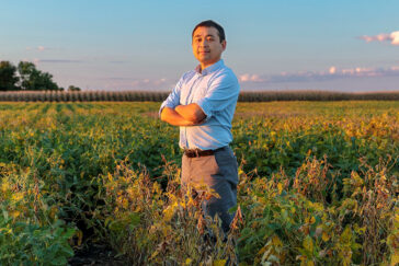 A researcher standing in an agricultural field