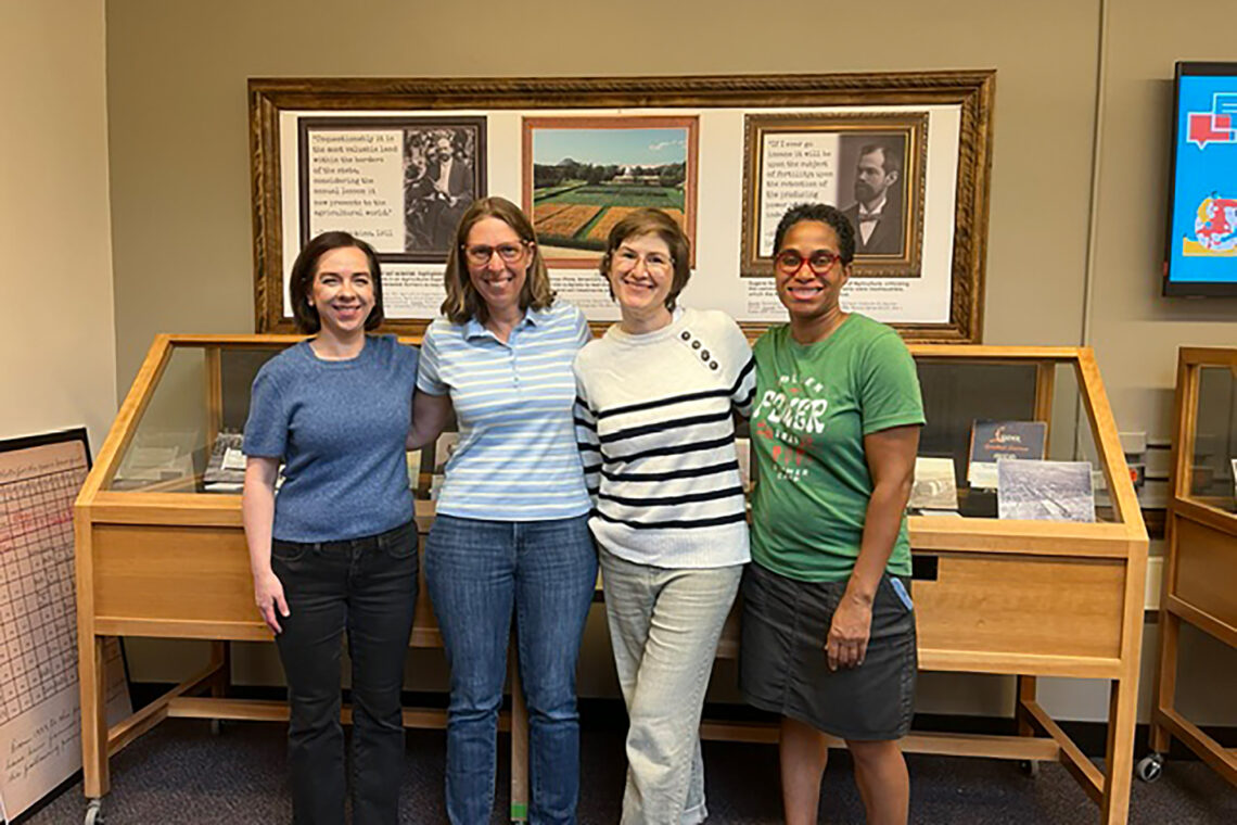 Photo of Bethany Anderson, Sarah C. Williams, Sandi Caldrone and Janis Shearer in front of an exhibit case.