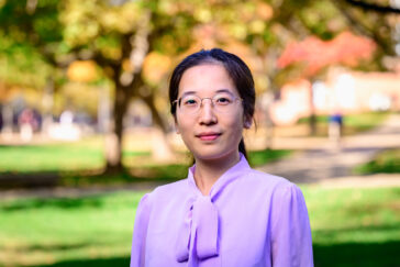 Photo portrait of Weiqing Qu outdoors.